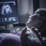 A mother listening to baby heartbeat.